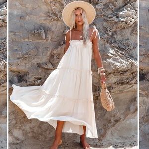 Beachy, flowy midi dress with adjustable tie straps.